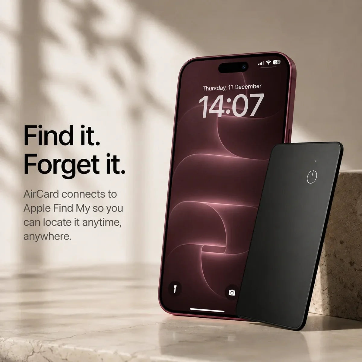 Black AirCard wallet tracker beside a Burgundy iPhone with matching wallpaper and lock screen.